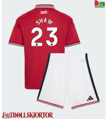 Manchester United Luke Shaw #23 Hemmakläder Barn 2026-27 Kortärmad (+ Korta byxor)